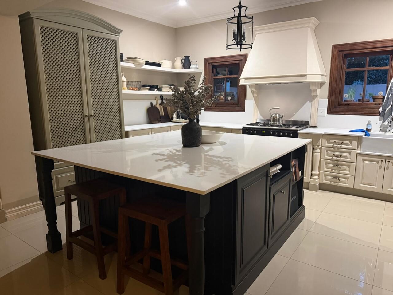 Classic kitchen with dark navy island and marble countertop